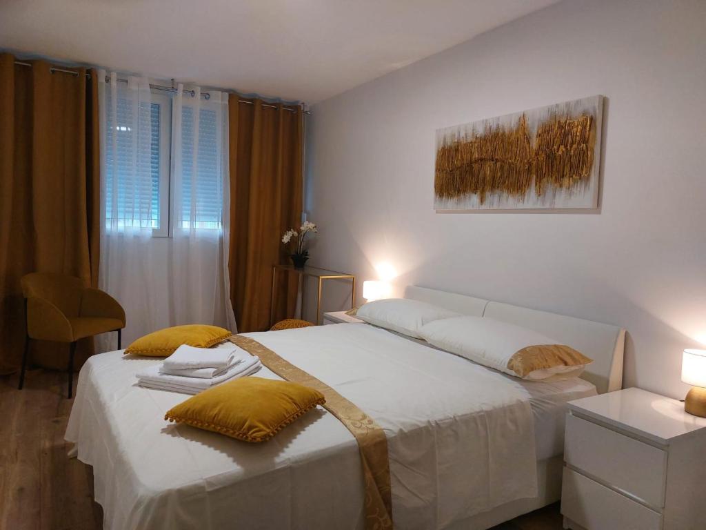 a bedroom with two beds with yellow pillows at Adriatic Loridas in Split