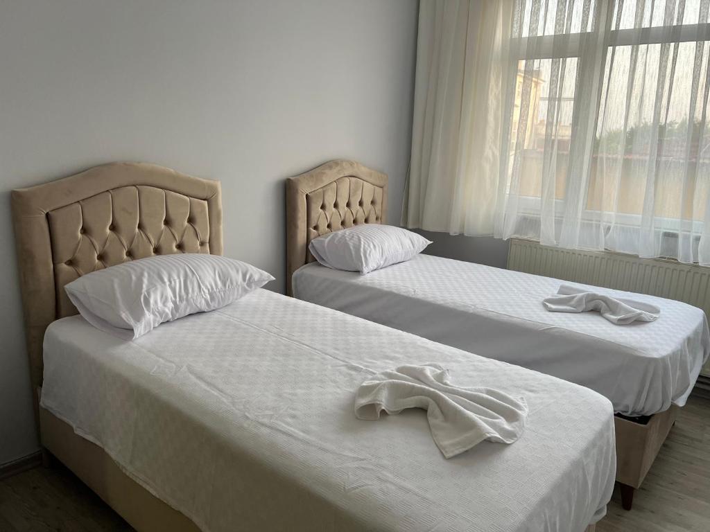 two beds with white towels on them in a room at Sultanahmet Corner Apart in Istanbul