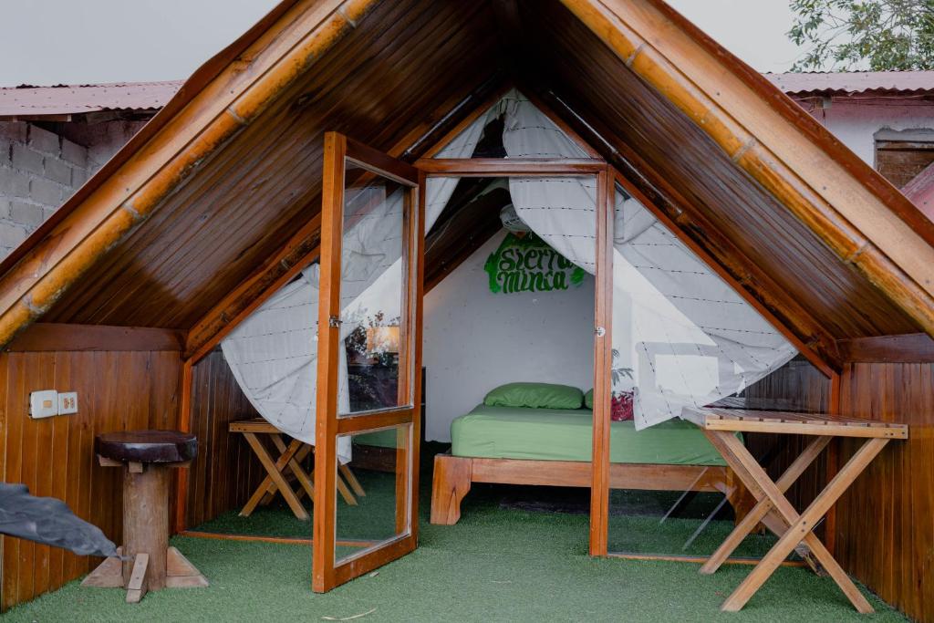 a room with a bed inside of a house at Hostal Sierra Minca in Minca