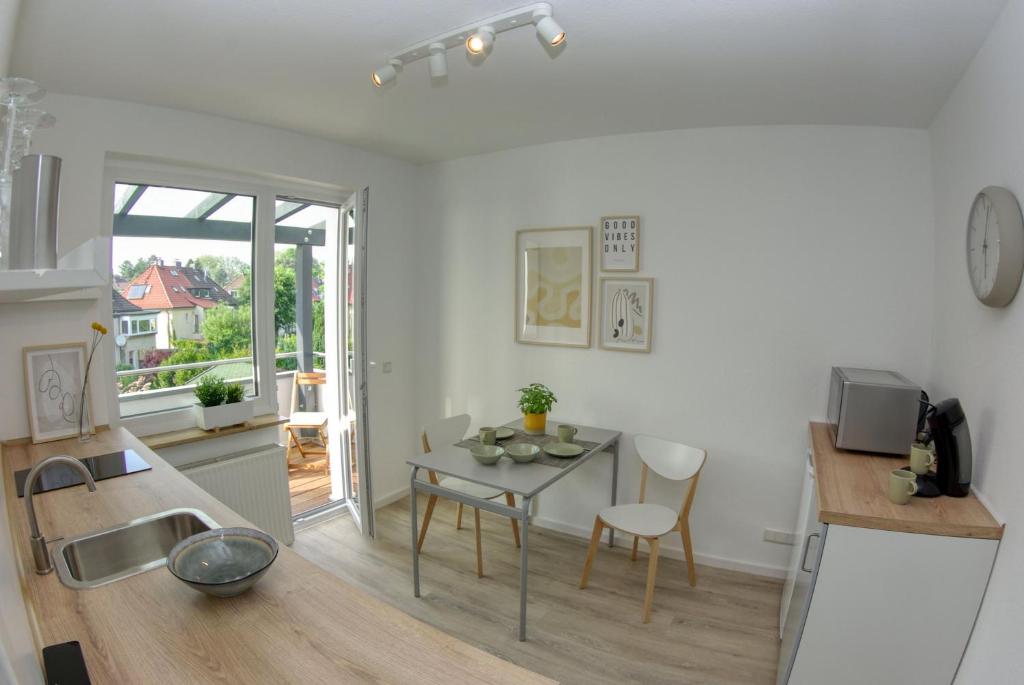 a kitchen and dining room with a table and a sink at Appartement mit Balkon Westfalenhalle und Universität fußläufig in Dortmund