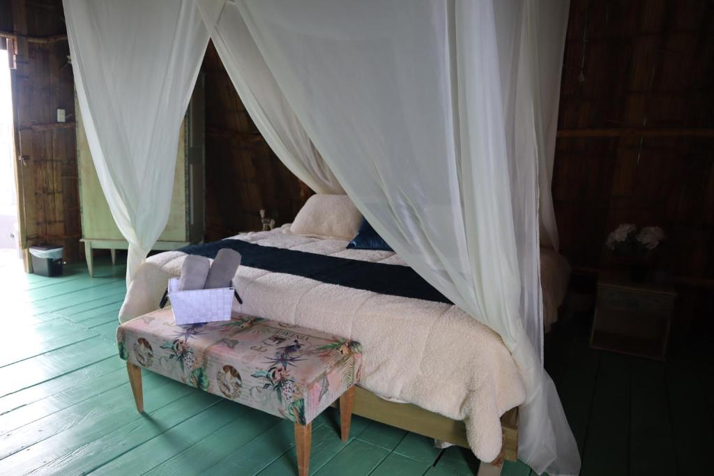 a bedroom with a bed with a canopy at Infinito Tatacoa in Villavieja