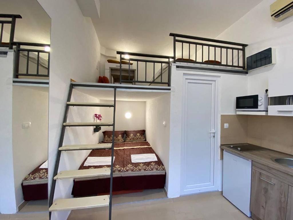 a room with two bunk beds and a kitchen at Sutorange in Sutomore