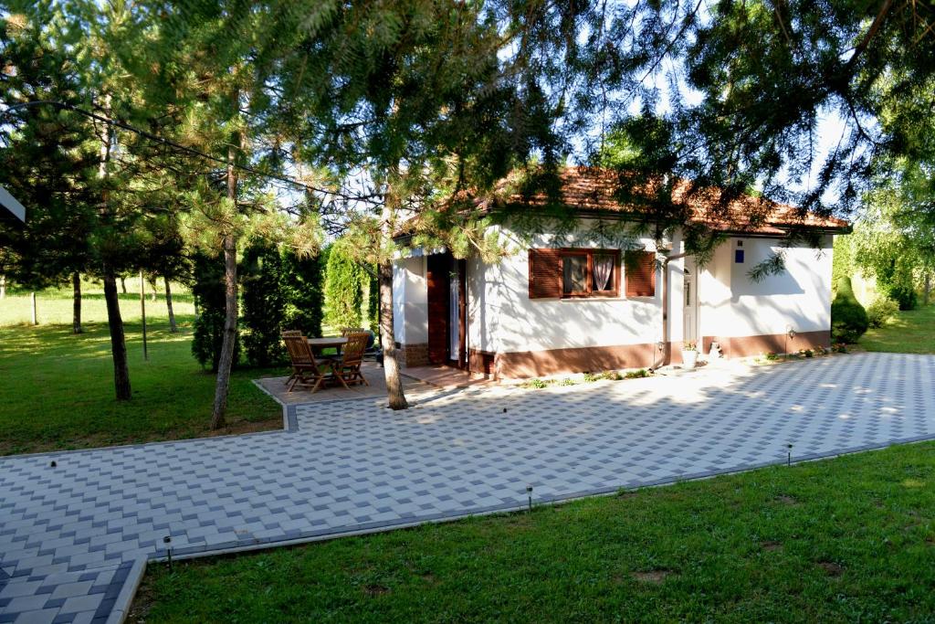 a small house with a patio in a yard at Kuća za odmor Čanić gaj in Gospić
