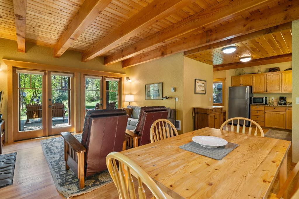 a kitchen and dining room with a wooden table and chairs at Metolius Cabin 1 in Camp Sherman