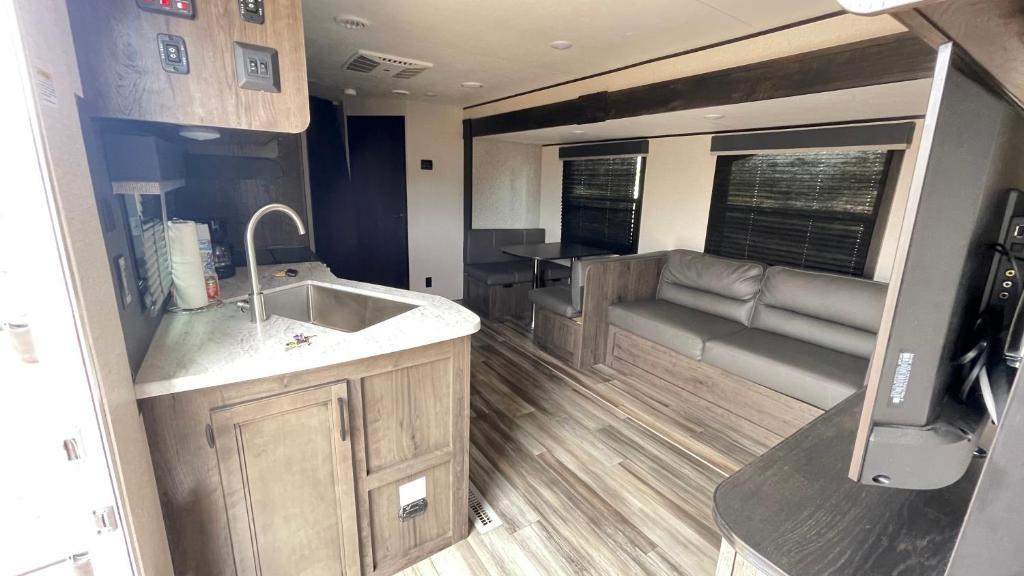 an rv kitchen with a sink and a couch at RV3 Wonderfull RV in MOVAL private freeparking Netflix in Moreno Valley