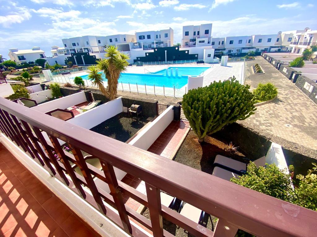 a balcony with a view of a swimming pool at Casa Inma Las Piteras. Sol y agua in Costa Teguise