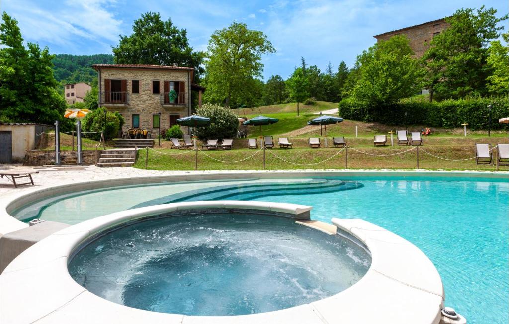 a large swimming pool in a yard with a house at Valguerriera - Orzo in Apecchio