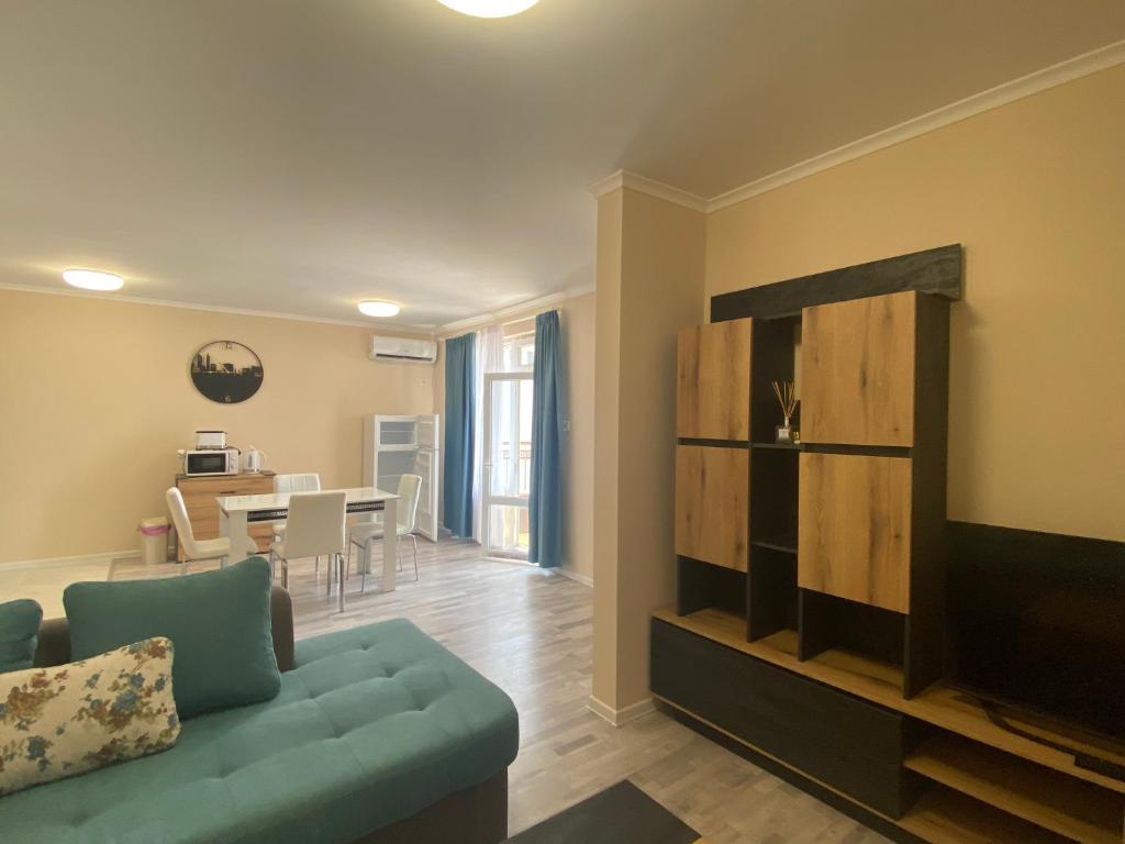 a living room with a couch and a dining room at MARINA BAY 23 Sveti Vlas Beach in Sveti Vlas