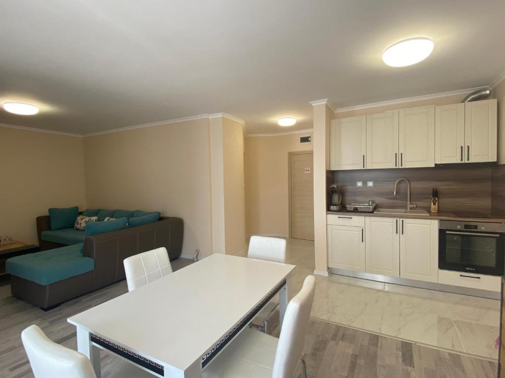 a kitchen and a living room with a table and chairs at MARINA BAY 23 Sveti Vlas Beach in Sveti Vlas