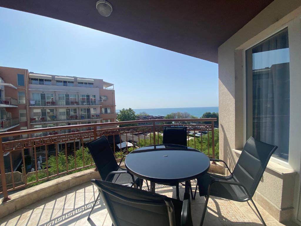 a patio with a table and chairs on a balcony at MARINA BAY 23 Sveti Vlas Beach in Sveti Vlas