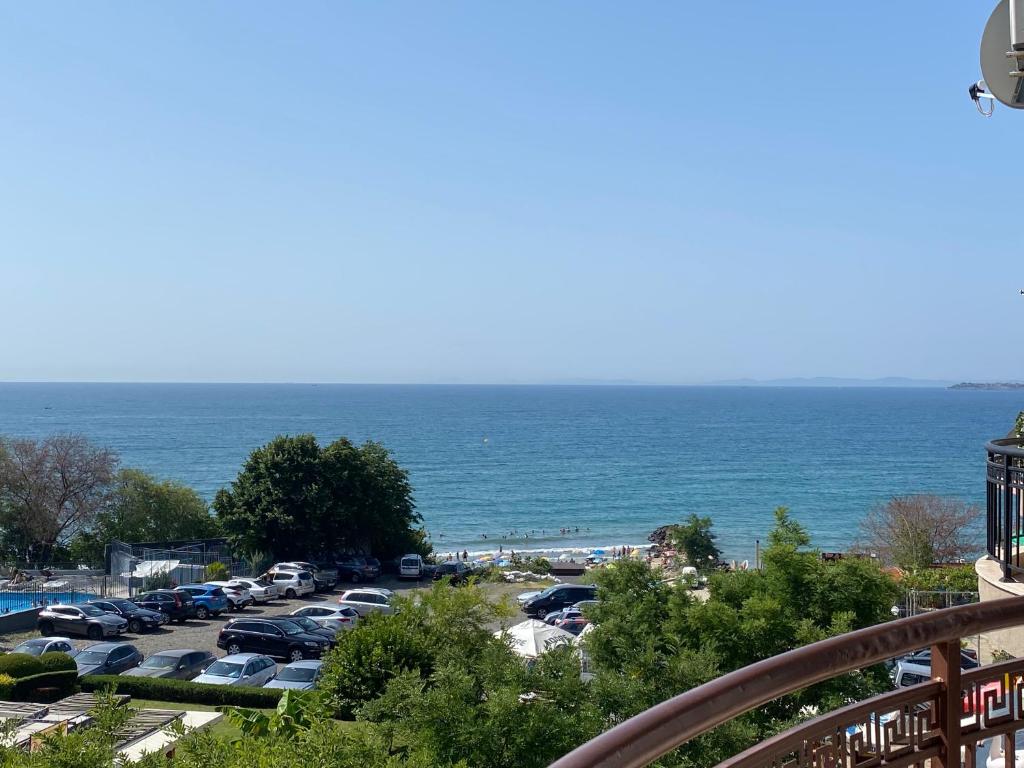 a parking lot with cars parked next to the ocean at MARINA BAY 23 Sveti Vlas Beach in Sveti Vlas