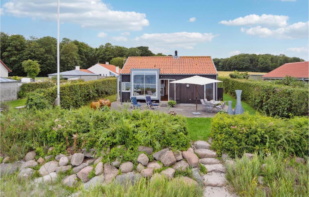 a small house with a garden in front of it at Amazing Home In Nyborg With Kitchen in Nyborg
