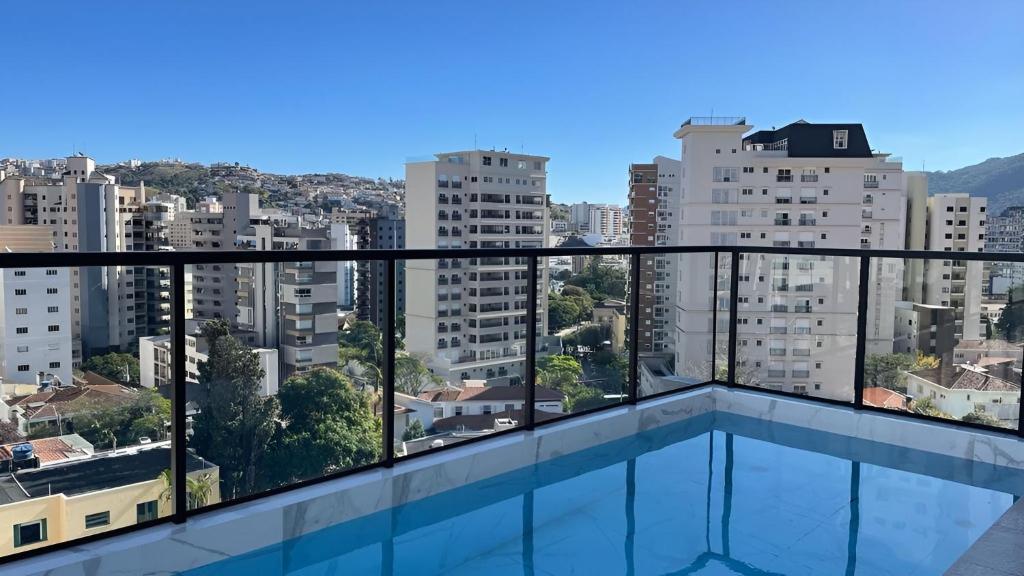 a balcony with a view of a city at Apartamento Centro Poços de Caldas in Poços de Caldas