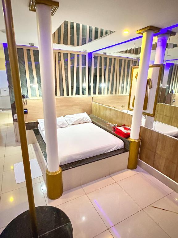 a bed in a room with columns at Shopping Motel in Castanhal