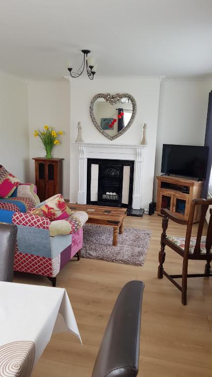 a living room with a couch and a fireplace at Comfortable Family Home in Immingham in Immingham