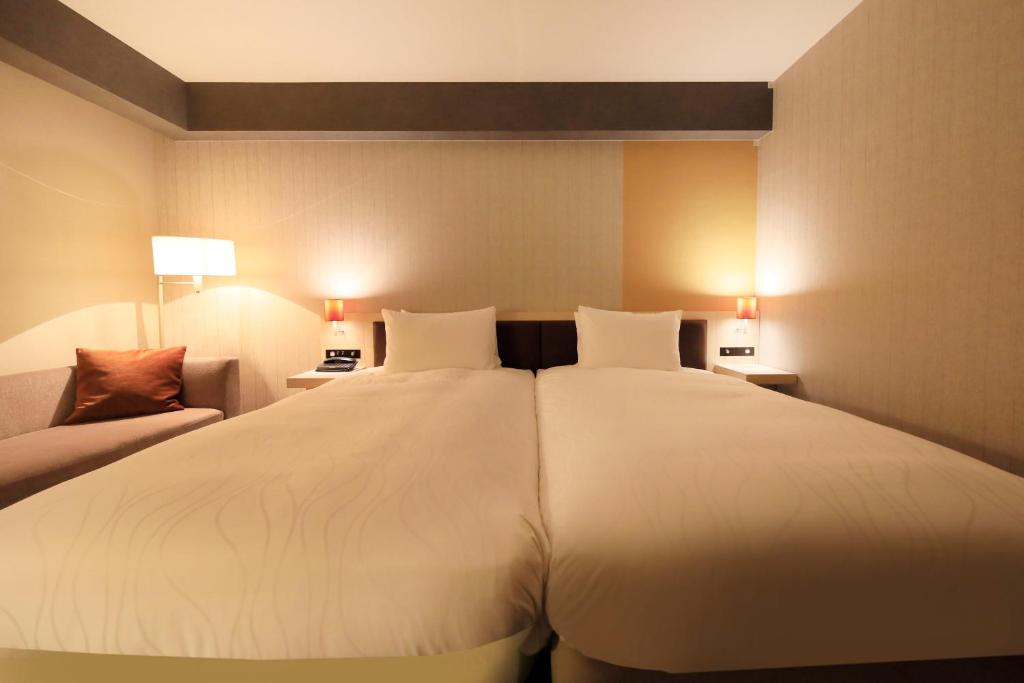 Postel nebo postele na pokoji v ubytování Richmond Hotel Narita