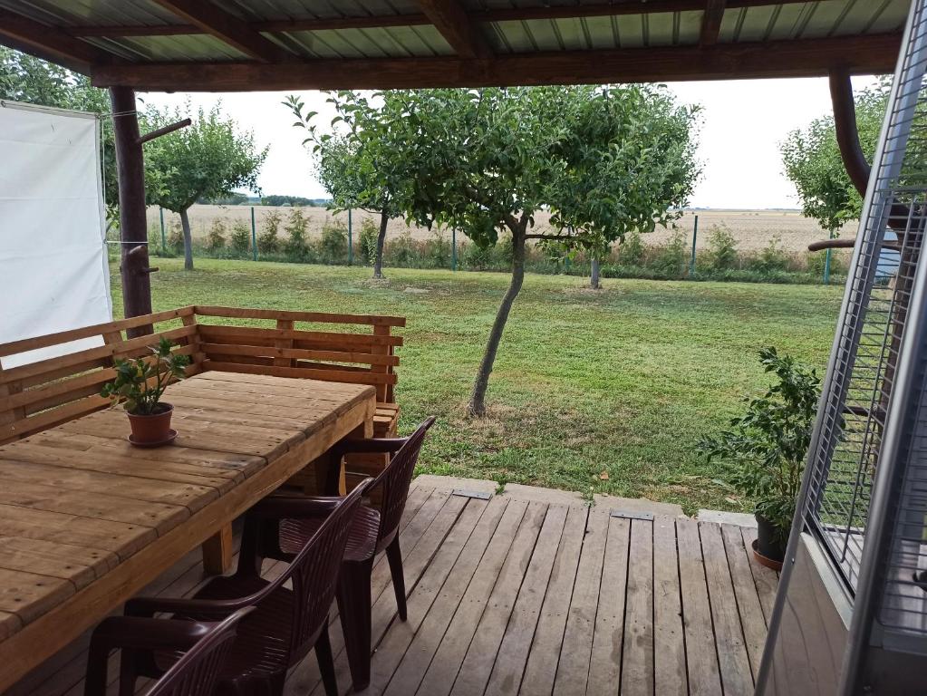 a wooden table and chairs on a wooden deck at Odpočinek na venkově 