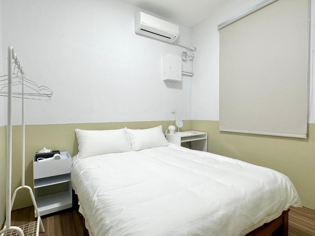 Postel nebo postele na pokoji v ubytování 衛民家 wei min home