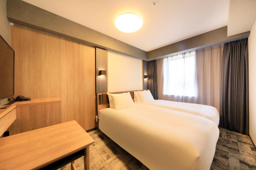 Postel nebo postele na pokoji v ubytování Richmond Hotel Narita