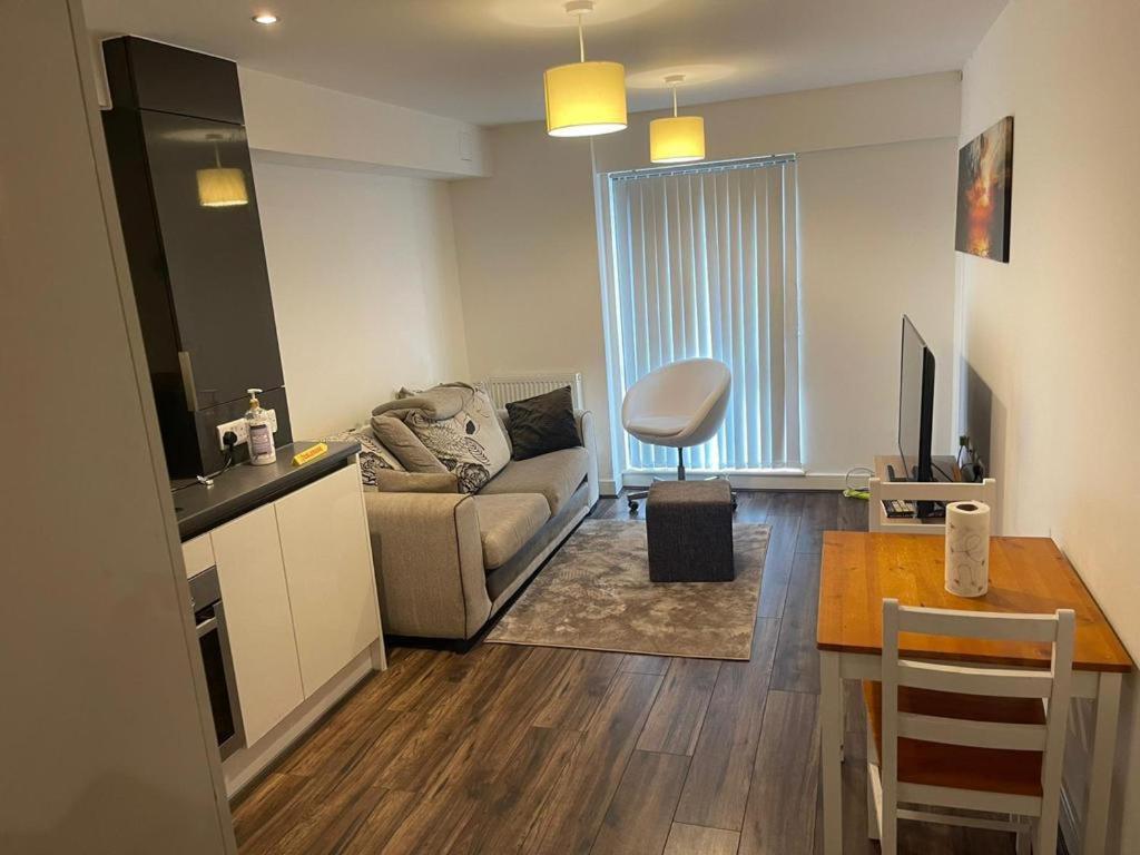 a living room with a couch and a table at Modern/Spacious Apartment in Digbeth (5 minute walk from Bullring) in Birmingham