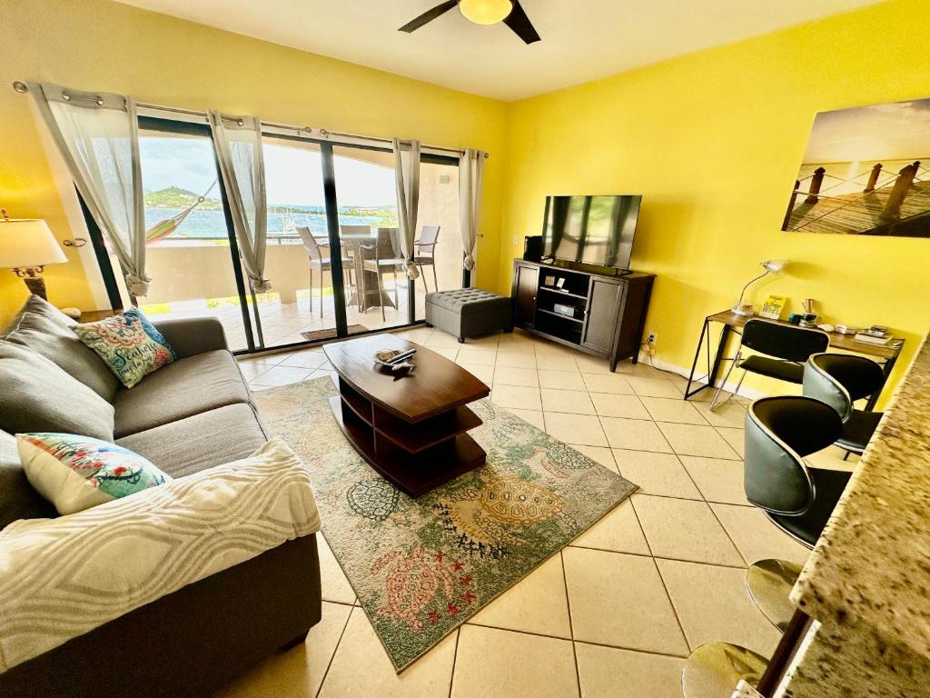 a living room with a couch and a table at Amazing View 1 Bed1 Bath Villa On Red Hook Strip in St Thomas