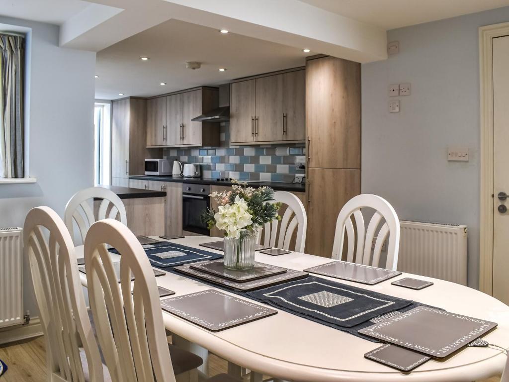 a kitchen and dining room with a table and chairs at The Beach House in Ramsgate