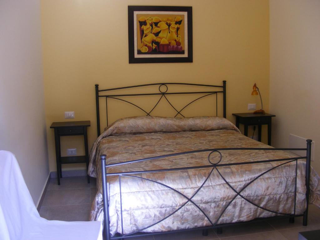 a bedroom with a bed and a picture on the wall at B&B FreeZone in Modugno