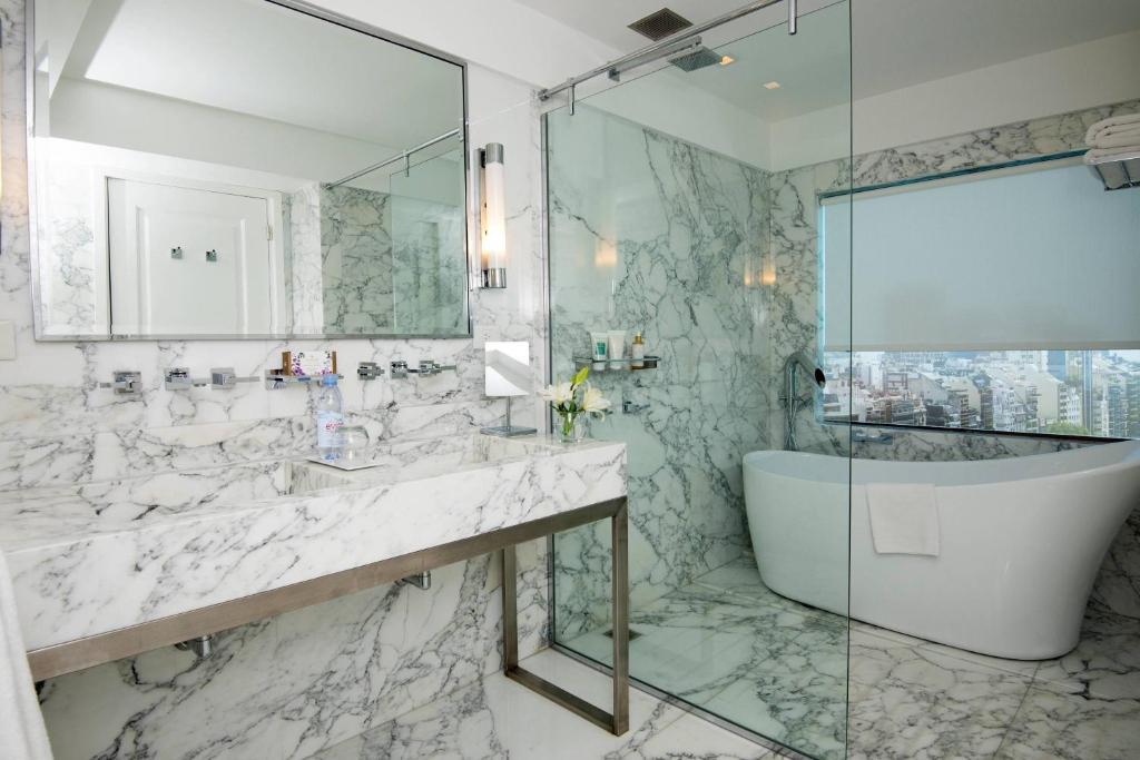 a bathroom with a tub and a sink and a shower at Buenos Aires Marriott in Buenos Aires