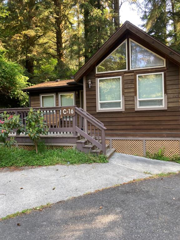 a brown house with a porch and a house with windows at Whaleshead Beach Resort in Brookings