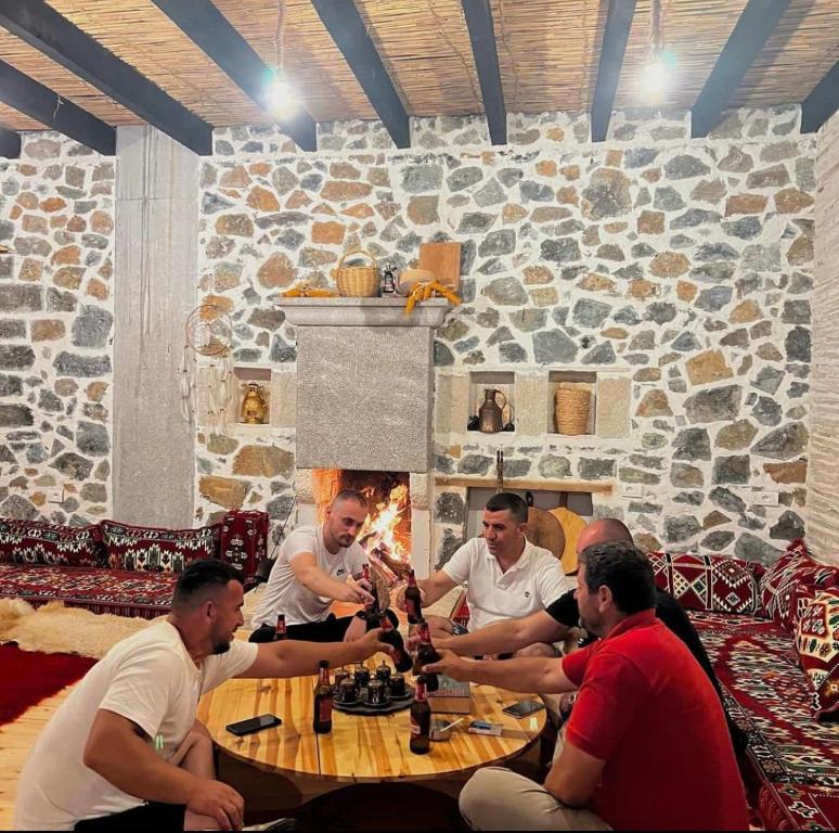Peshkopi的住宿－Bujtina Oxhaku i Docit，一群坐在桌子旁的人