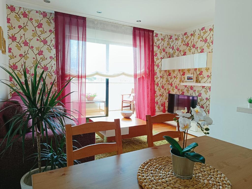 a dining room with a wooden table and a dining room at Atico Rias Baixas in Vilagarcia de Arousa