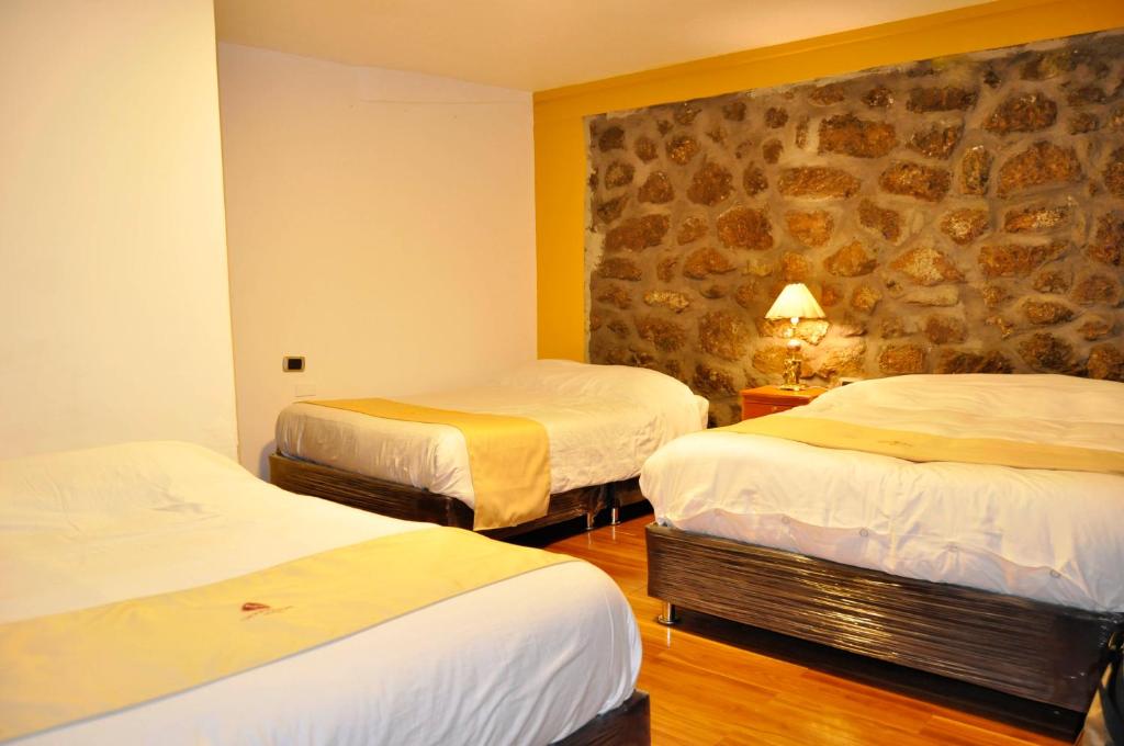 Postel nebo postele na pokoji v ubytování Hotel Choquequirao