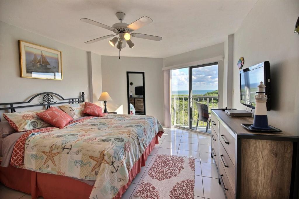 a bedroom with a bed and a flat screen tv at 2306 Ocean Pointe in Tavernier