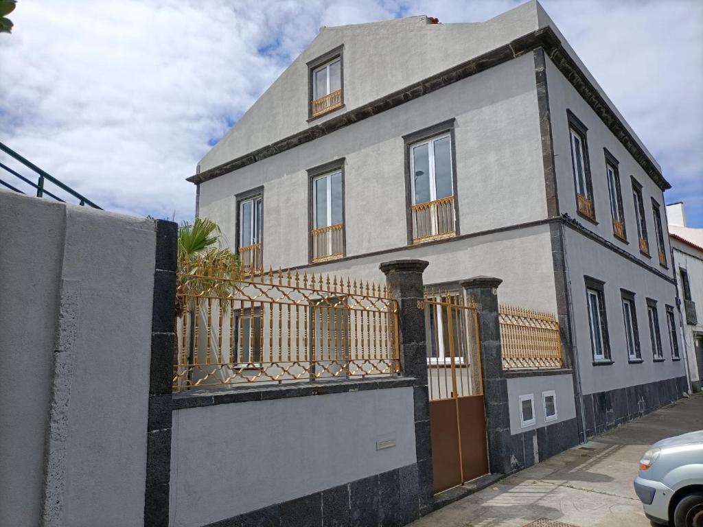 a building with a fence in front of it at Seaside House in Ponta Delgada