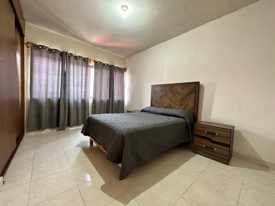 a bedroom with a bed and a dresser in it at Casa Pavón in Morelia