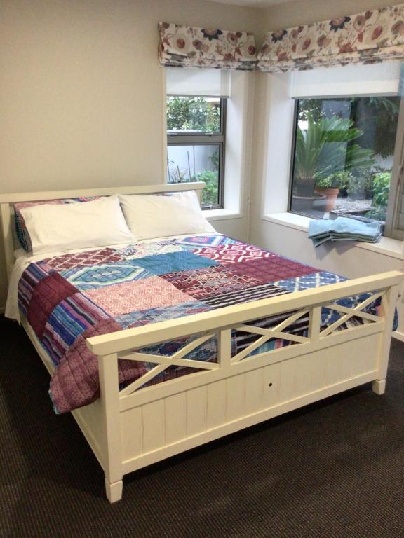 a bedroom with a large bed with a window at Beachside studio in New Plymouth
