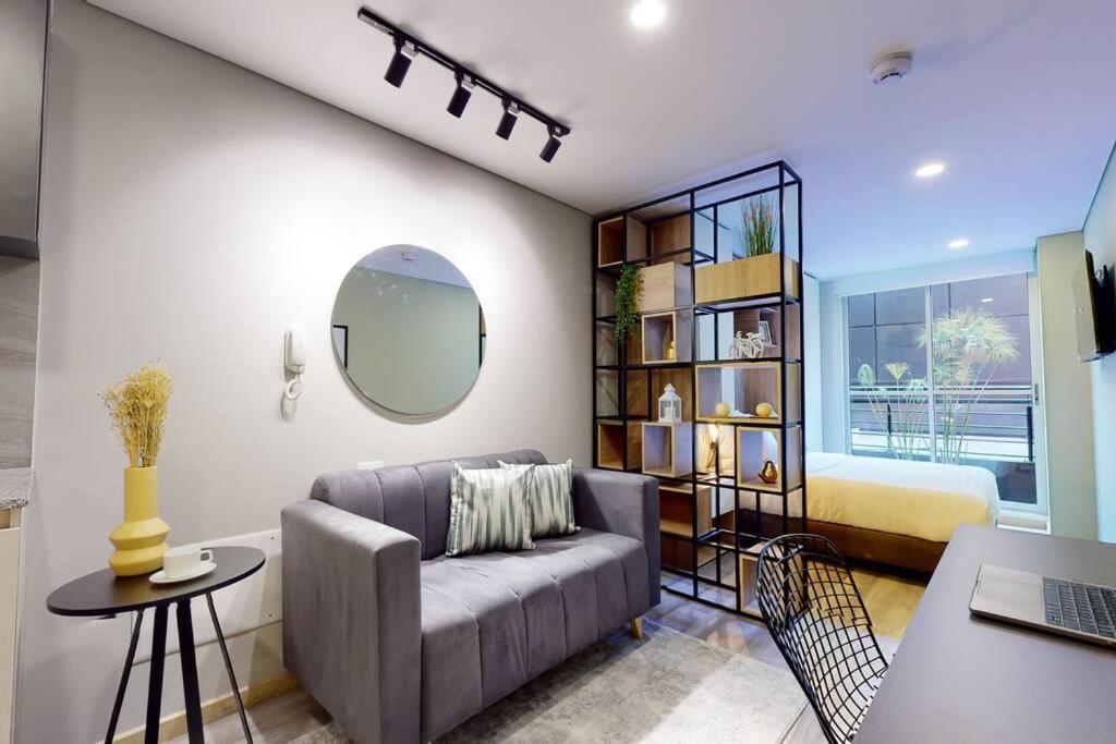 a living room with a couch and a bed at Exclusivo Loft Cabrera 85-12 in Bogotá