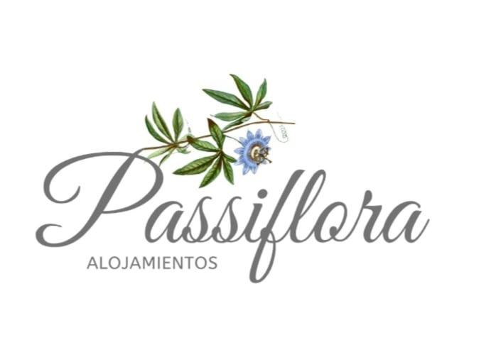 a logo for a restaurant with a blue flower at Casa Passiflora II in Villa Elisa