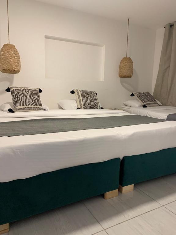 Postel nebo postele na pokoji v ubytování Hotel Quintas de Normandia