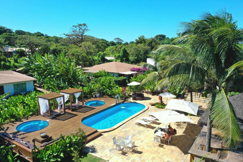 an aerial view of a swimming pool with palm trees at Dolphin Hotel in Fernando de Noronha