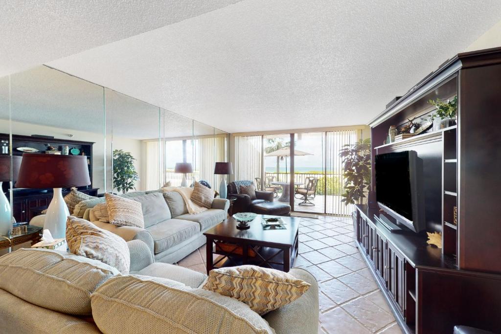 a living room with a couch and a tv at Lighthouse Towers #206 in Clearwater Beach
