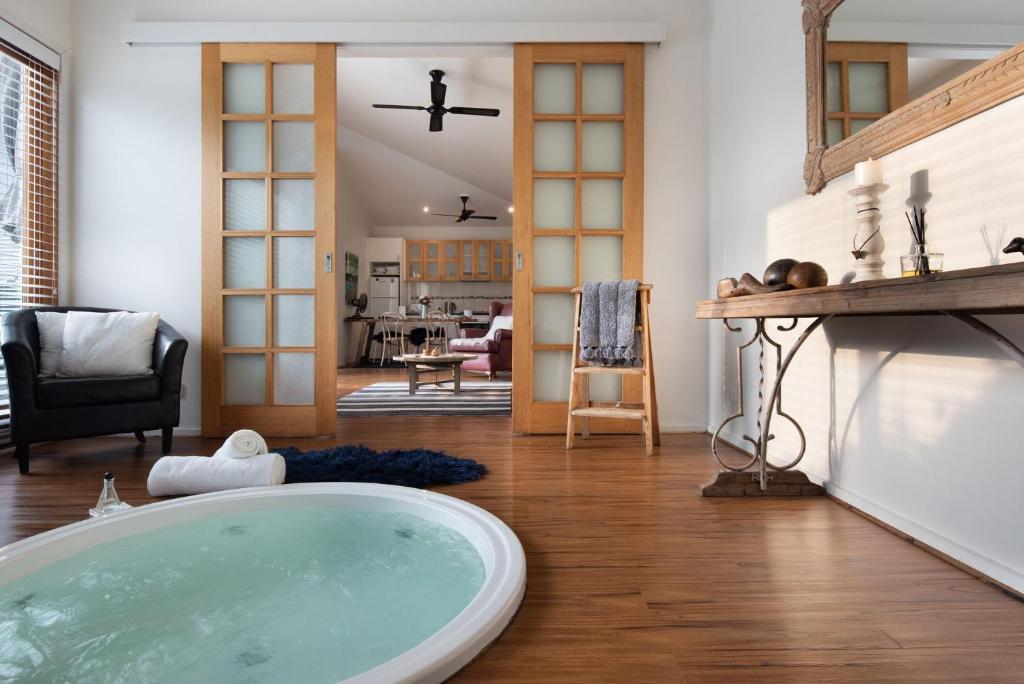 a bathroom with a tub in the middle of a room at Gables Bend Spa Villa in Daylesford