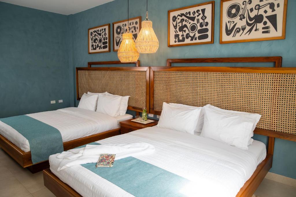 Postel nebo postele na pokoji v ubytování Jama Campay - Homes Resort & Spa