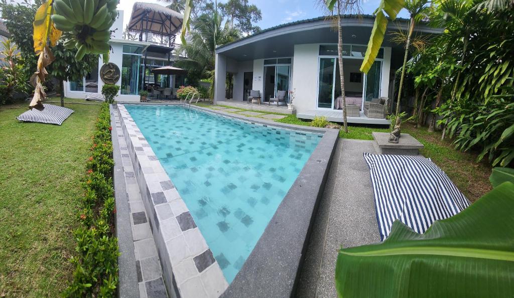 a swimming pool in front of a house at Samui Paradise Villa in Lipa Noi