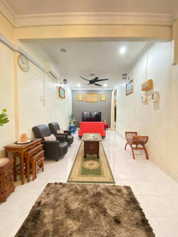 a living room with a couch and a table at The Z Homestay in Jitra