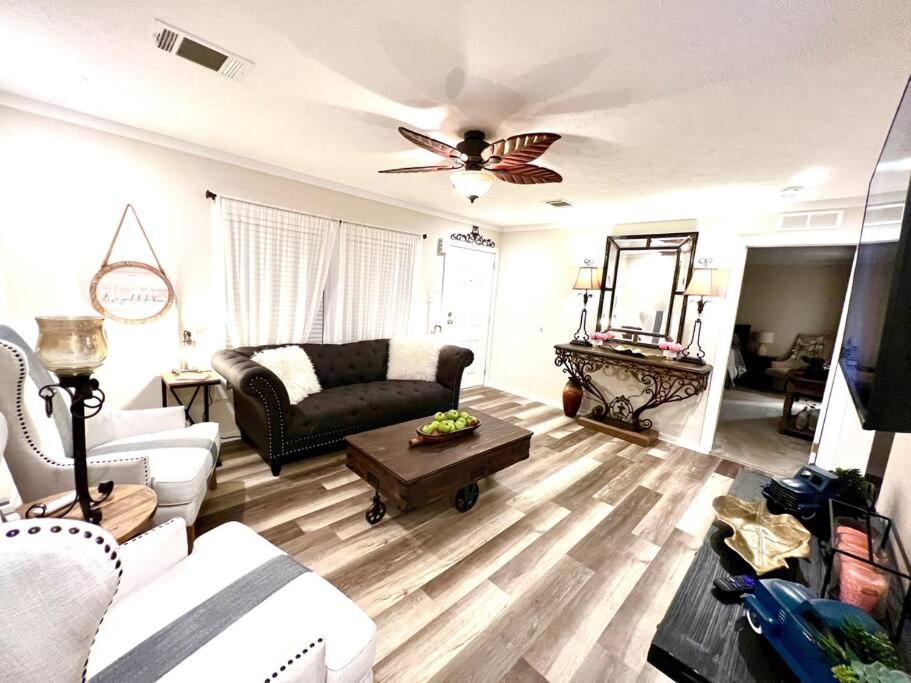 a living room with a couch and a ceiling fan at Pink Flamingo House in Cocoa