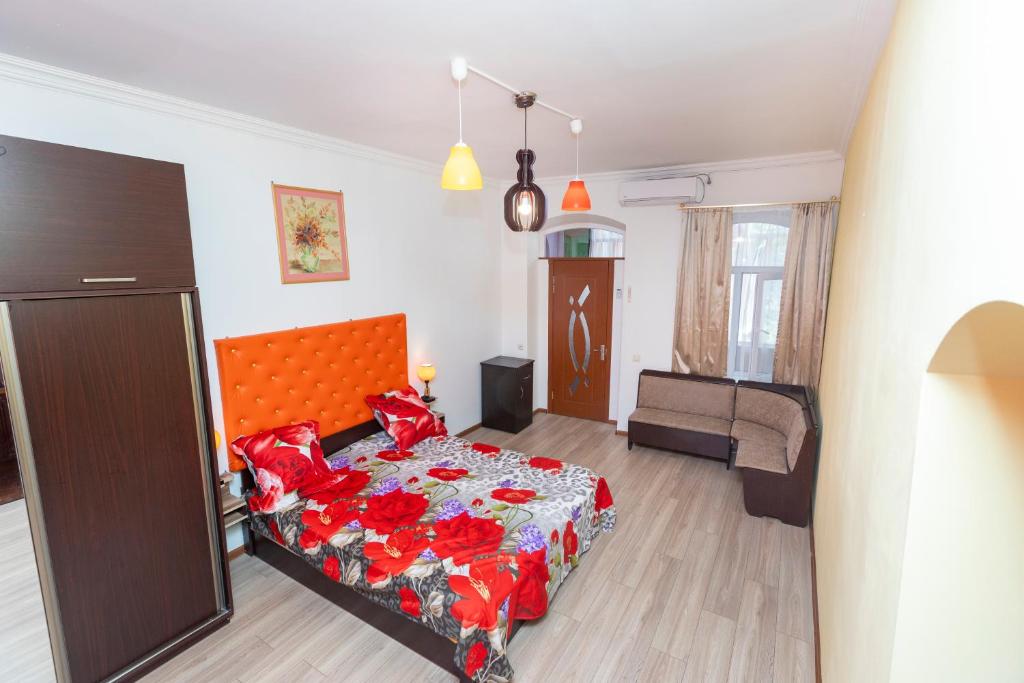 a bedroom with a bed with red pillows at Homestay in Tbilisi center GM in Tbilisi City
