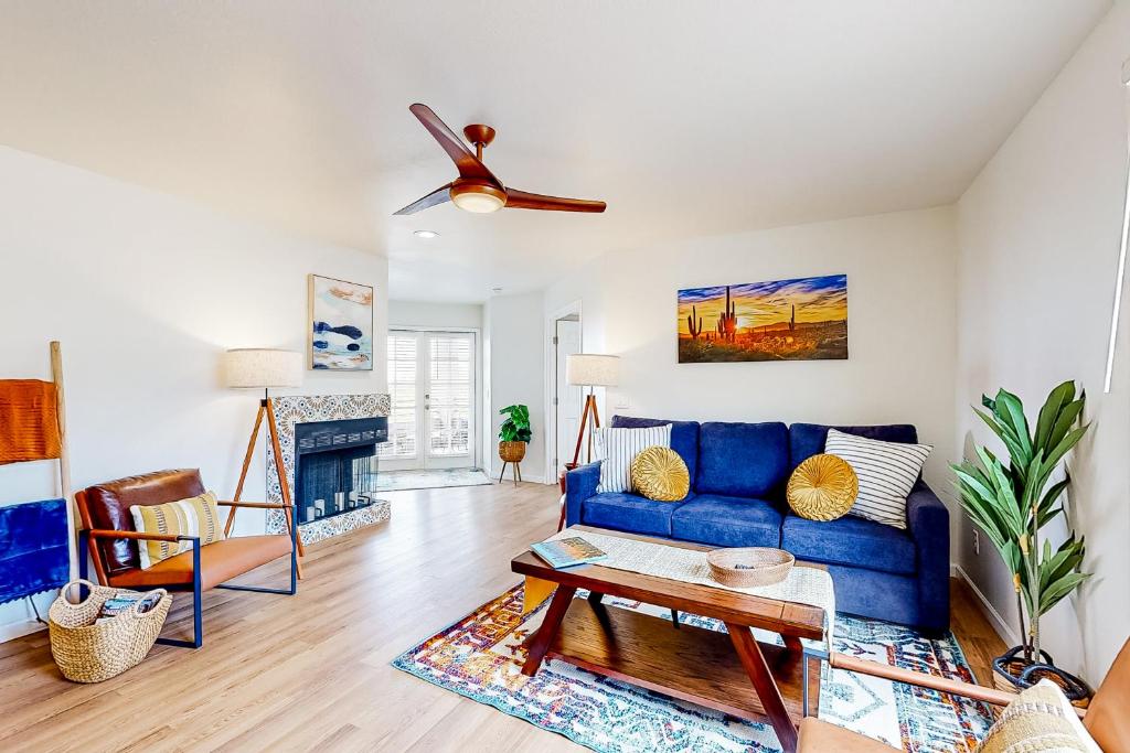 a living room with a blue couch and a table at Canyon Oasis- Canyon View #3214 in Tucson