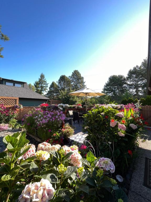 a garden filled with lots of different colored flowers at Garden home in Victoria -Beautiful home in Victoria in Victoria