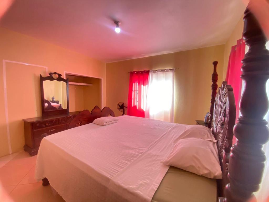 a bedroom with a large bed and a mirror at PINE VALLEY ESTATES 9b BALCONY VIEW TWO BEDROOM 2 BATHROOMS 